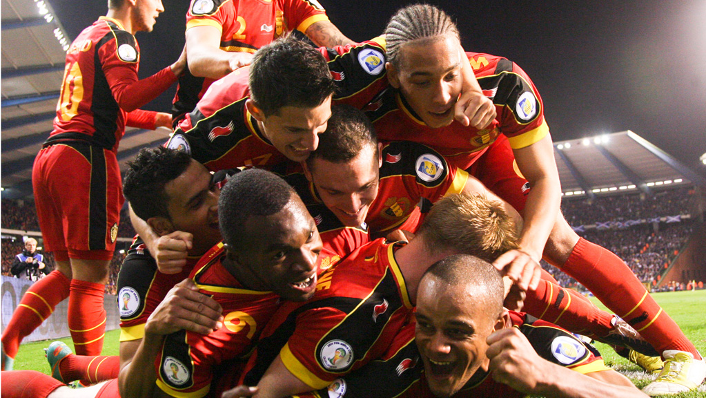 Belgium's Vincent Kompany (bottom) celebrates with teammates after scoring the 2-0 goal during the 2014 World Cup qualifying football match between Belgium and Scotland at the King Baudouin stadium in Brussels, on October 16, 2012. AFP PHOTO / BELGA / VIRGINIE LEFOUR  *** Belgium Out ***        (Photo credit should read VIRGINIE LEFOUR/AFP/Getty Images)