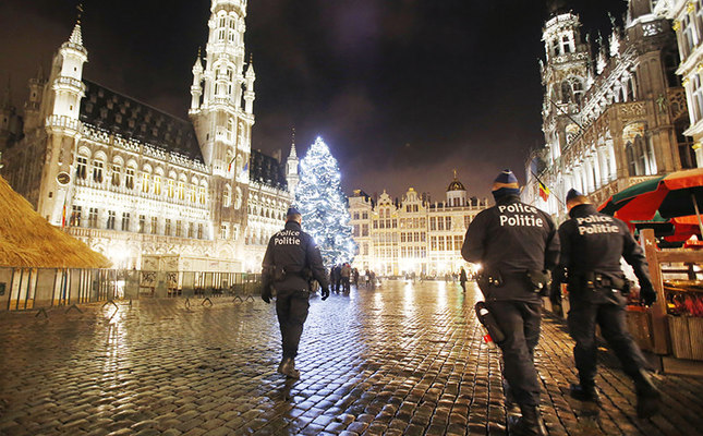 Belgian police officers patrol the Grand Place in downtown Brussels, Belgium, Monday, Nov. 23, 2015. The Belgian capital Brussels has entered its third day of lockdown, with schools and underground transport shut and more than 1,000 security personnel deployed across the country. (AP Photo/Michael Probst)